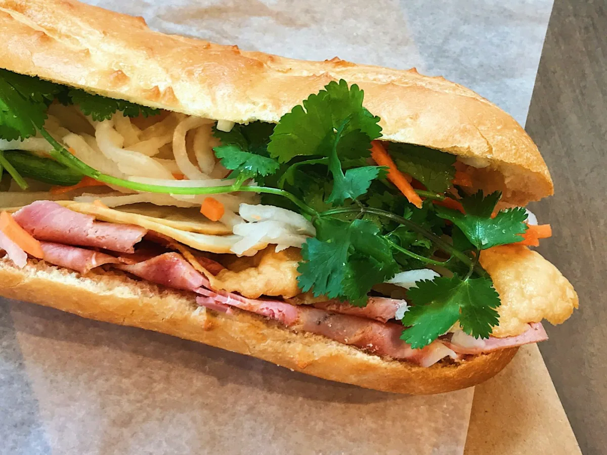 Vietnamese banh mi sandwich with pickled vegetables and fresh herbs